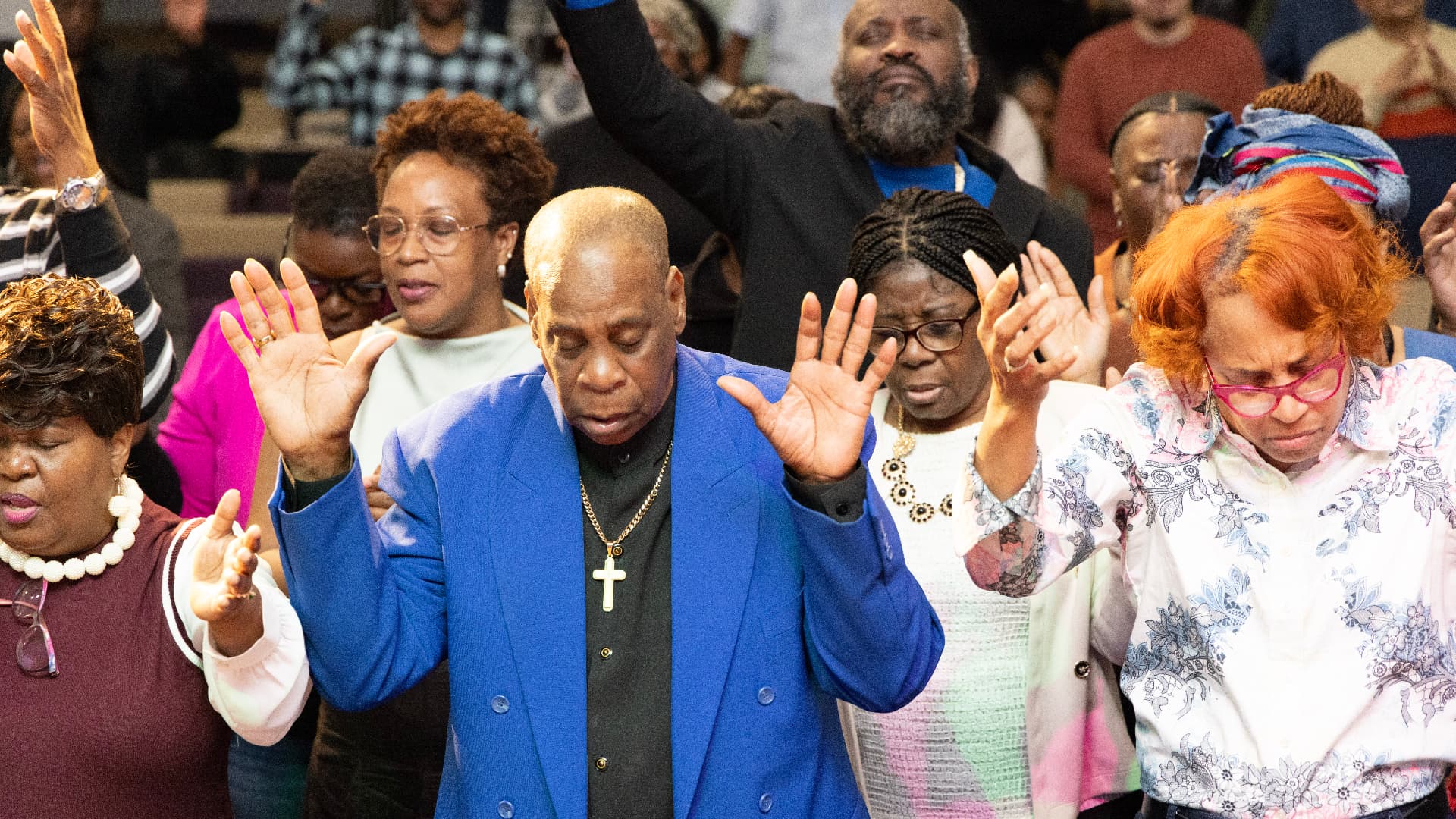 Congregation praying with hands raised