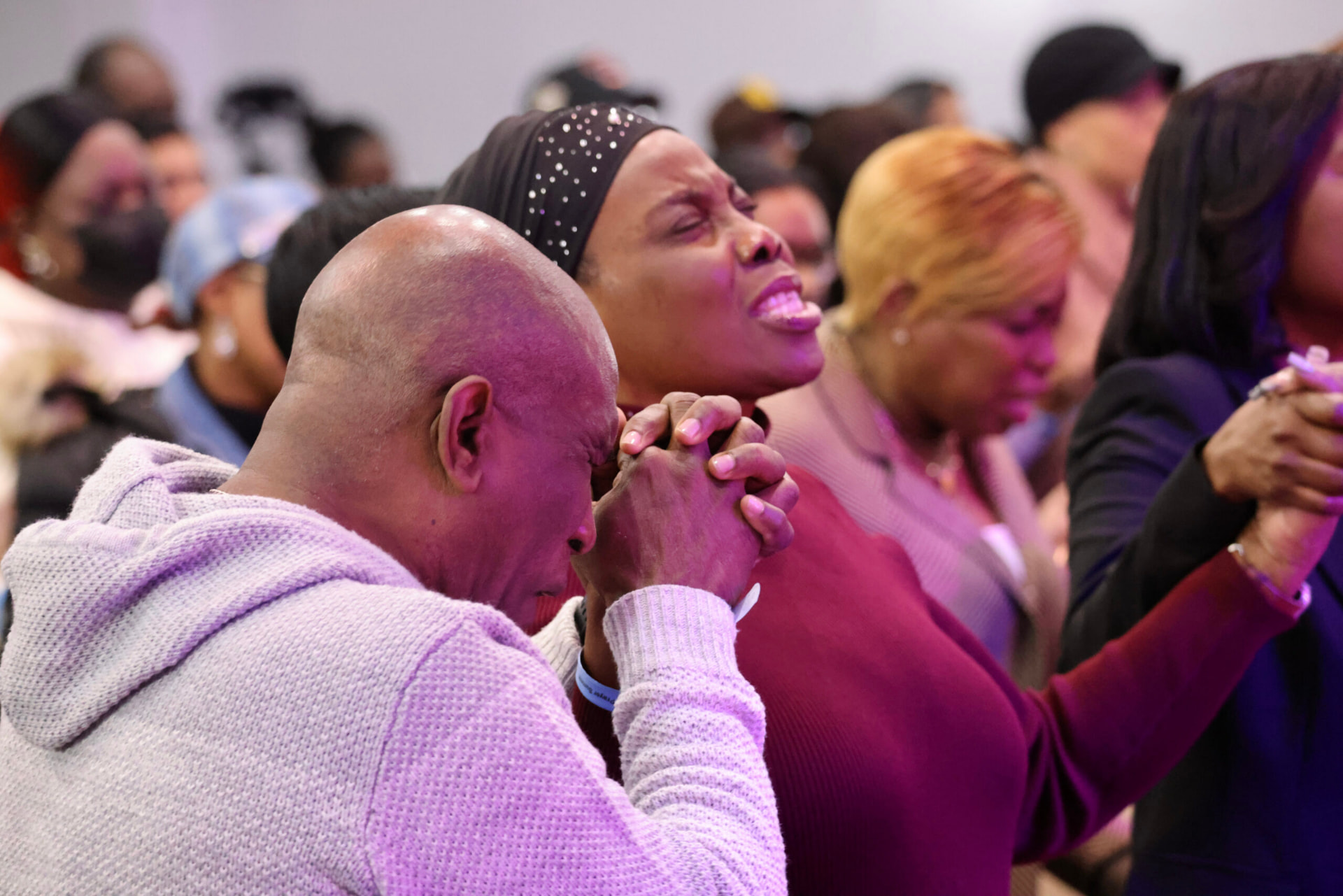 People praying with hands clasped